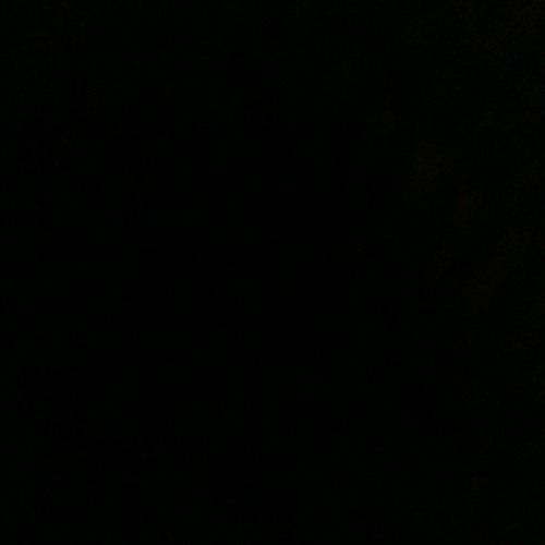 Pitch black, on my back in bed.
