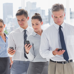 BERTIN - Office people as a team looking at their cell phones