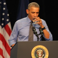 President Obama asks for a glass of water while speaking in Flint
