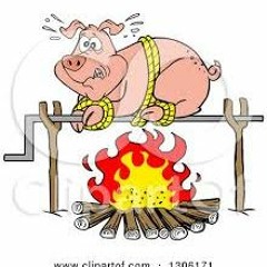 Roasting Pig Over A Fire On A Hot Summer Day by CBP