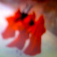four red monks carrying a black goat across the snow to nowhere