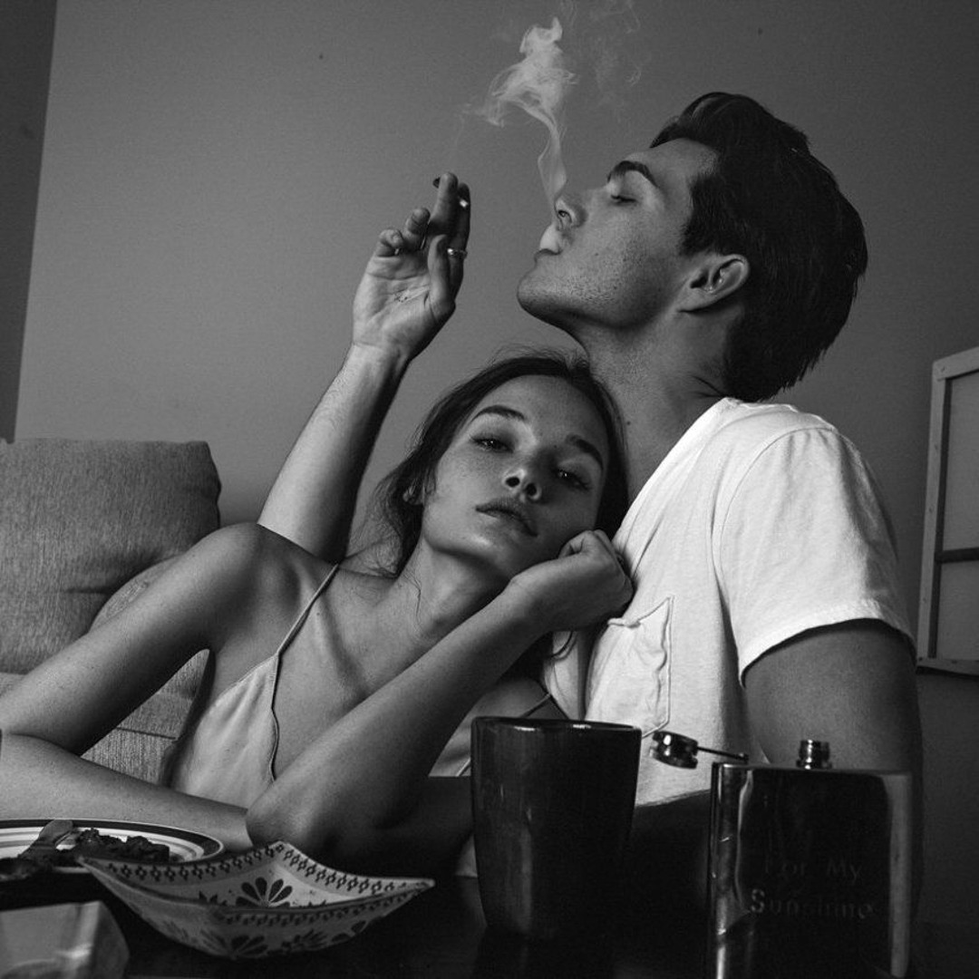 Relaxed couple embracing after intimacy