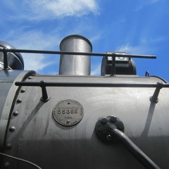 Steam train whistle at road crossing, distant, natural echo