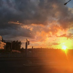 Riding a bike down a hill towards the sunset