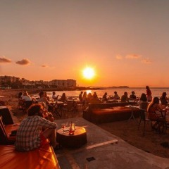 Sitting on a beach in Ibiza, watching the sun set