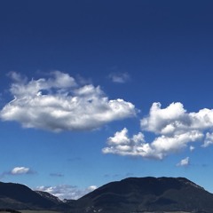 Under fluffy clouds