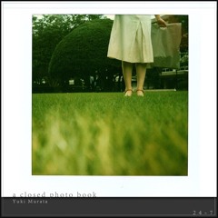 a closed photo book (Anoice / Yuki Murata '24 Piano Sketches')