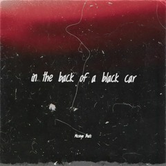 in the back of a black car