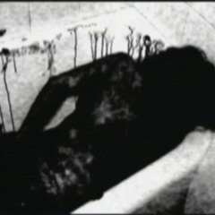 A woman bathed in blood having her arm amputated