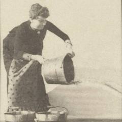 woman emptying bucket of water