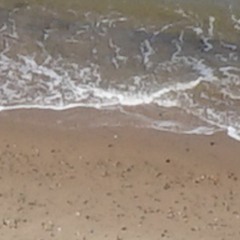 Waves on the shore as heard from under the sand.