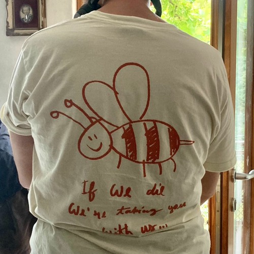 The image shows a shirt featuring smiling bee with a caption that reads "if we die we're taking you with us..."