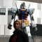 Guy in front of a Gundam Statue